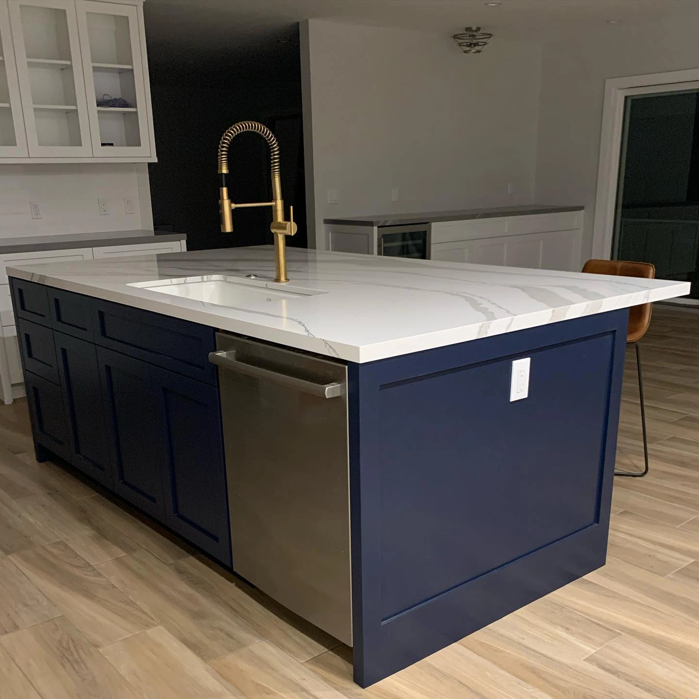 Kitchen island with marble countertop and Sherwin Williams Naval paint