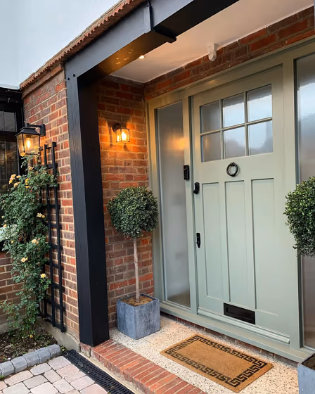 RAL Classic Cement grey RAL 7033 front door of the red brick house