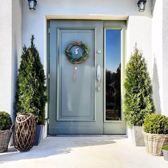 RAL Classic Cement grey RAL 7033 front door on a sunny day