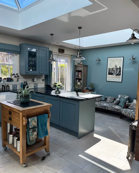 Oval Room Blue dusted blue kitchen cabinets and accent wall