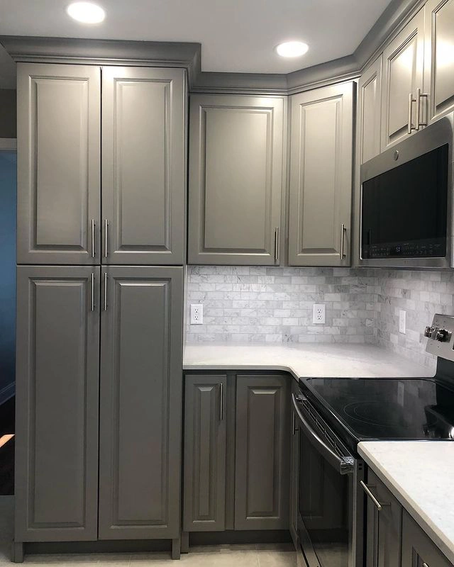 Dark grey kitchen cabinets painted in Dovetail Sherwin Williams