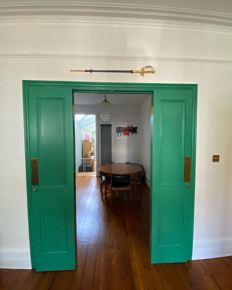 Green vintage door with white walls Little Greene Flint