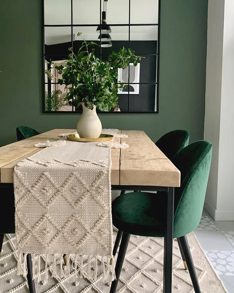 Green dining room with velvet chairs
