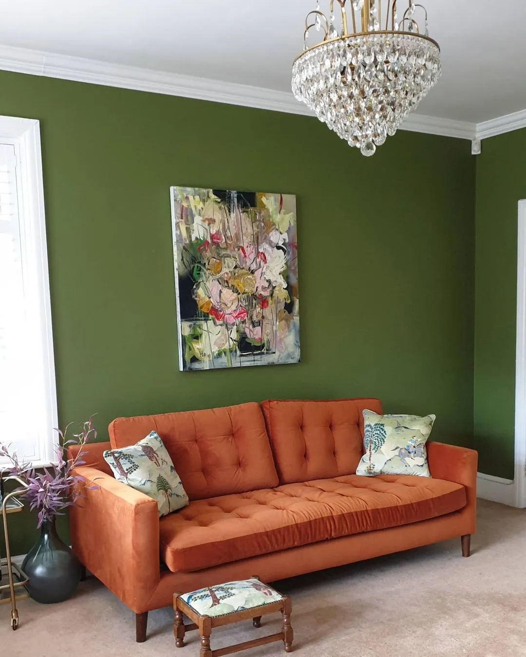 Green Sap living room with orange coach