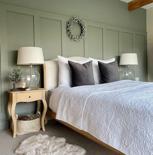 Cozy bedroom interior with olive walls